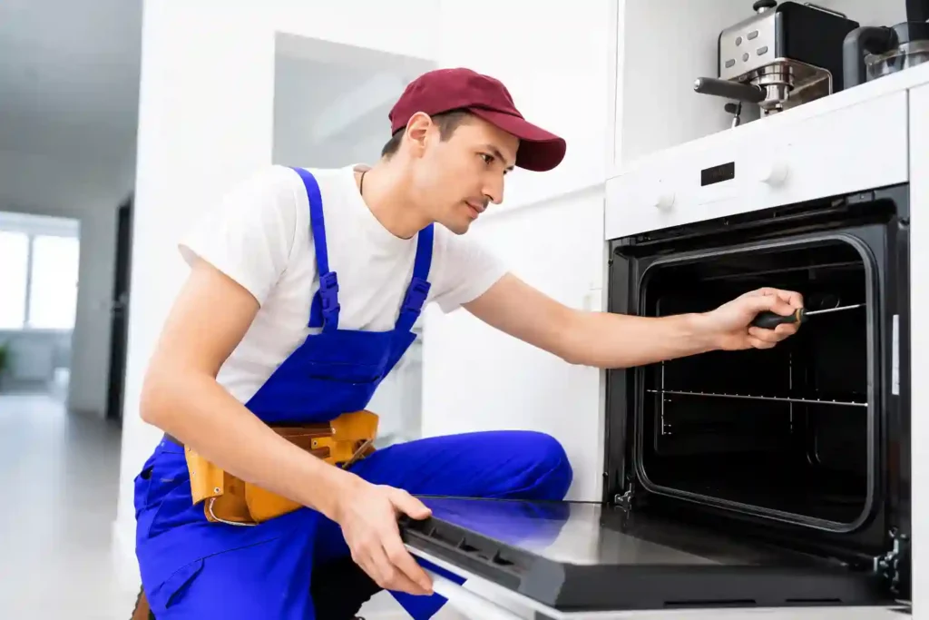 Technician inspecting the interior of a built-in oven.